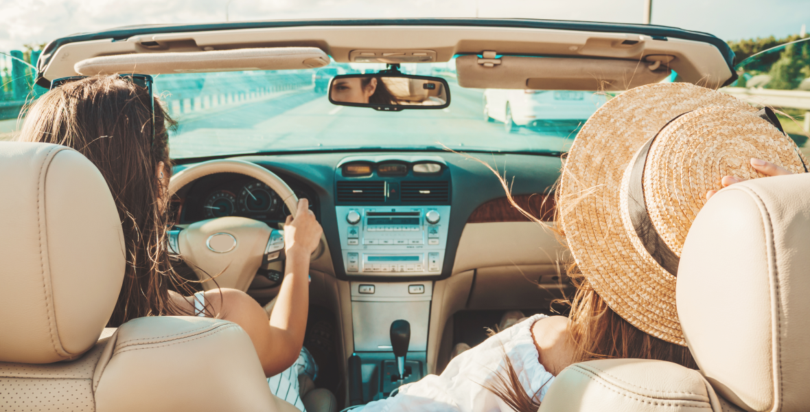 portrait-two-young-beautiful-smiling-hipster-female-convertible-car 1